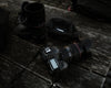 camera gear laid on a dark wood table