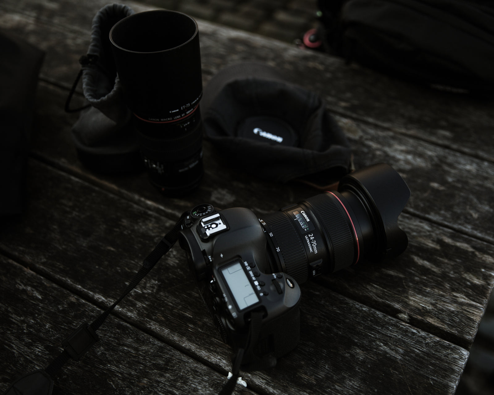 Camera gear laid out on a dark wood table ready to pack for travel