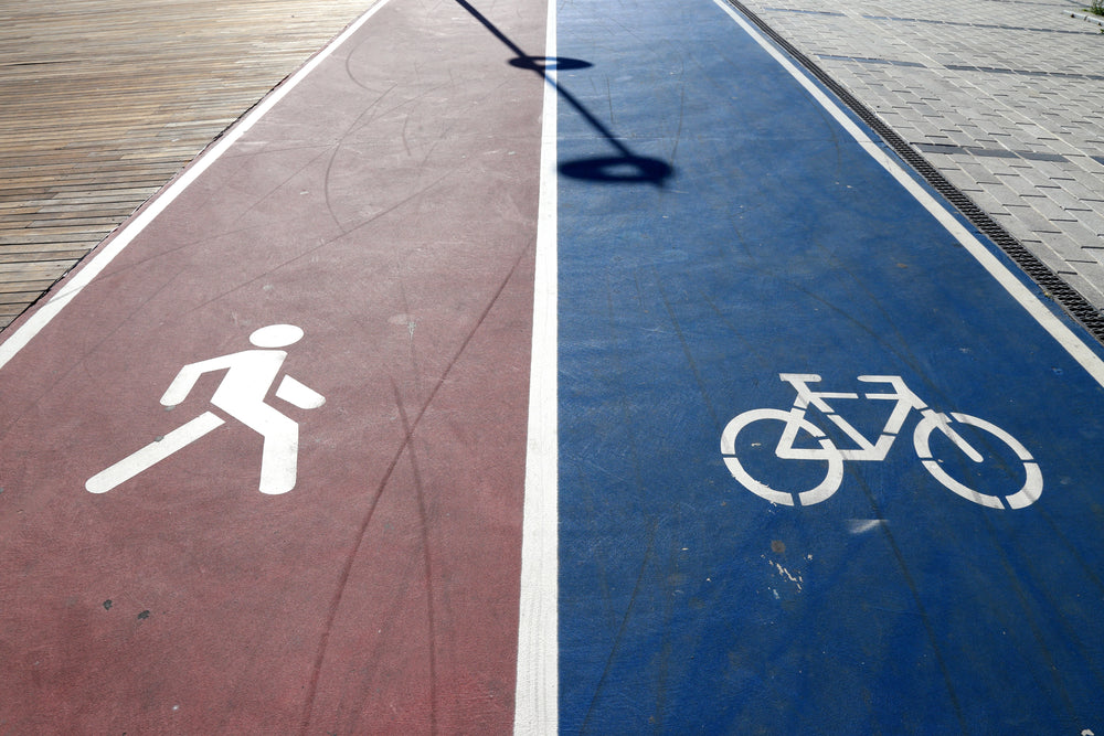 camera looks down at a bike path and walking path