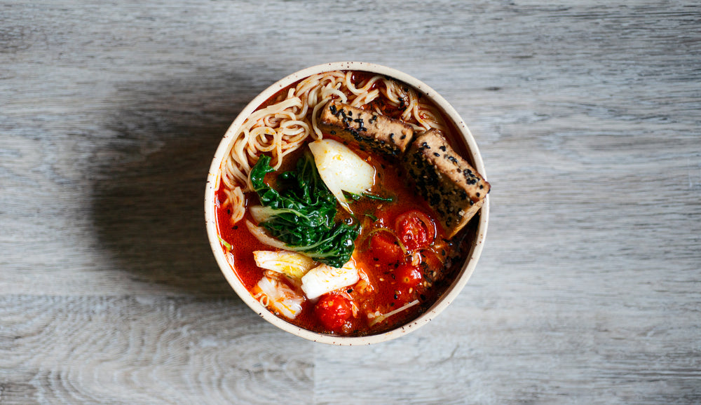 camera looks down at a bowl of noodle soup