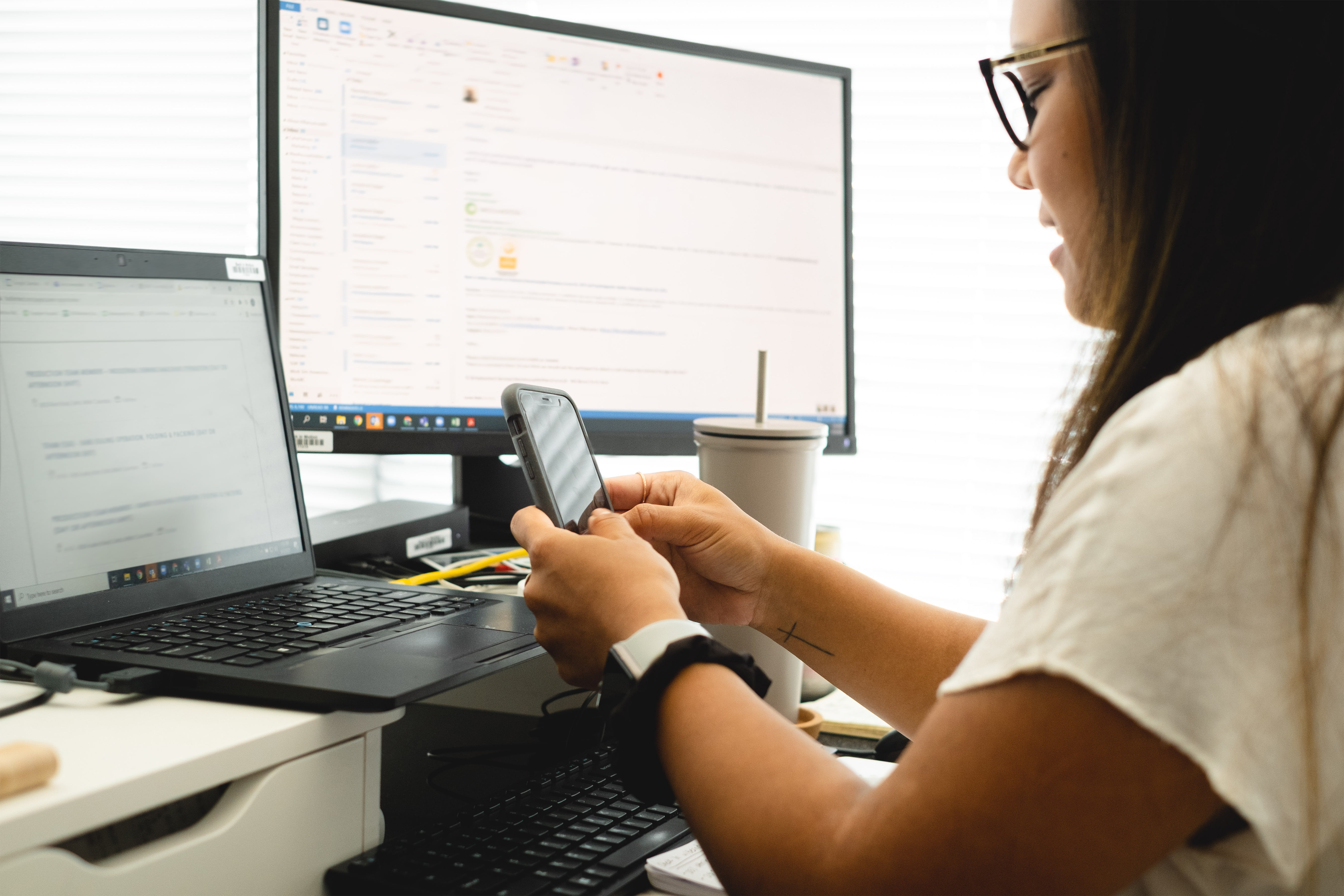 Camera Looks Over The Shoulder Of Person Working At A Desk