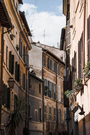 camera looks up to rustic building with open windows