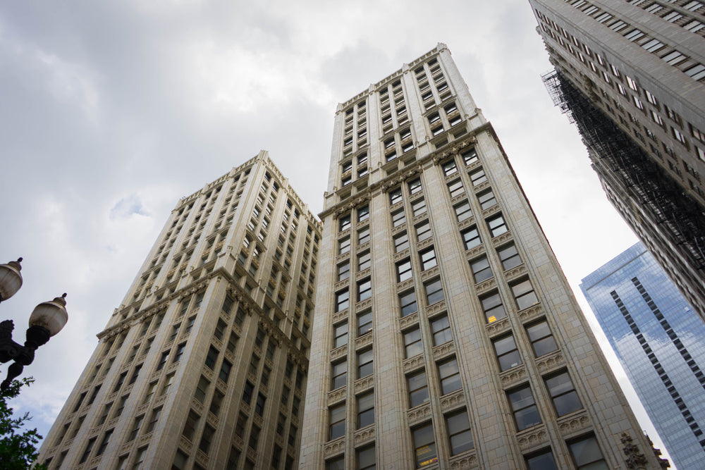 camera looks up towards the tops of two city buildings