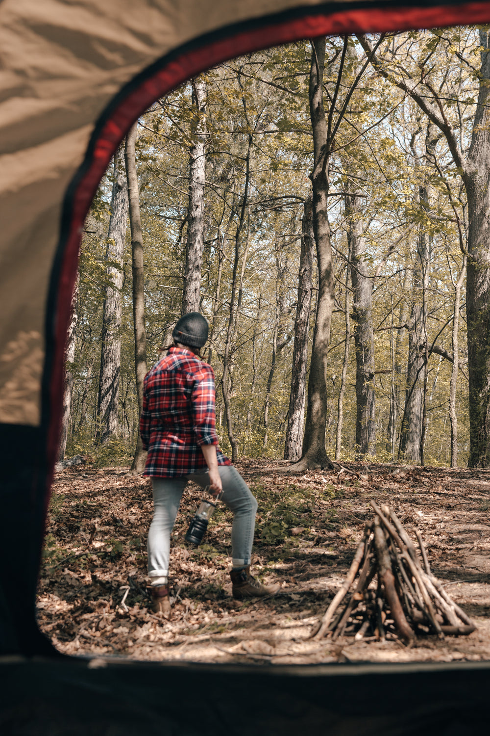 camper standing outside of tent