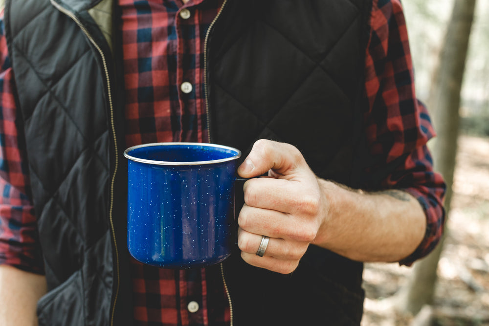 camping cup held by lumberjack