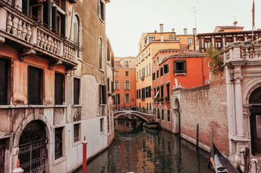 canal between buildings with a bridge