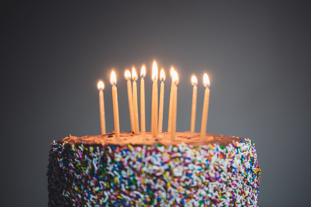 candles lit on chocolate cake