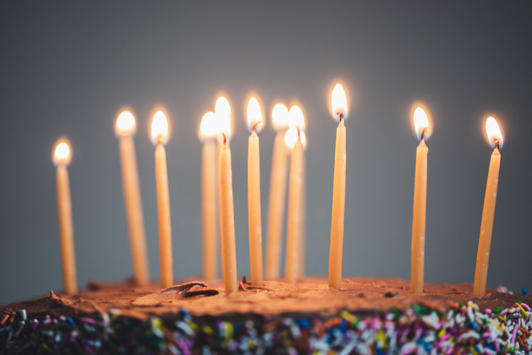 Candles On An Illuminated Chocolate Cake