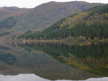 canoe in water by cliffs