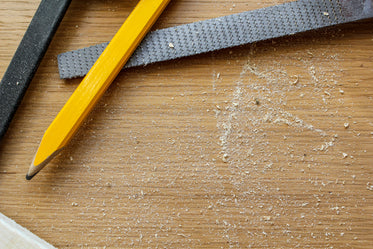 carpenter's pencil and tools in sawdust