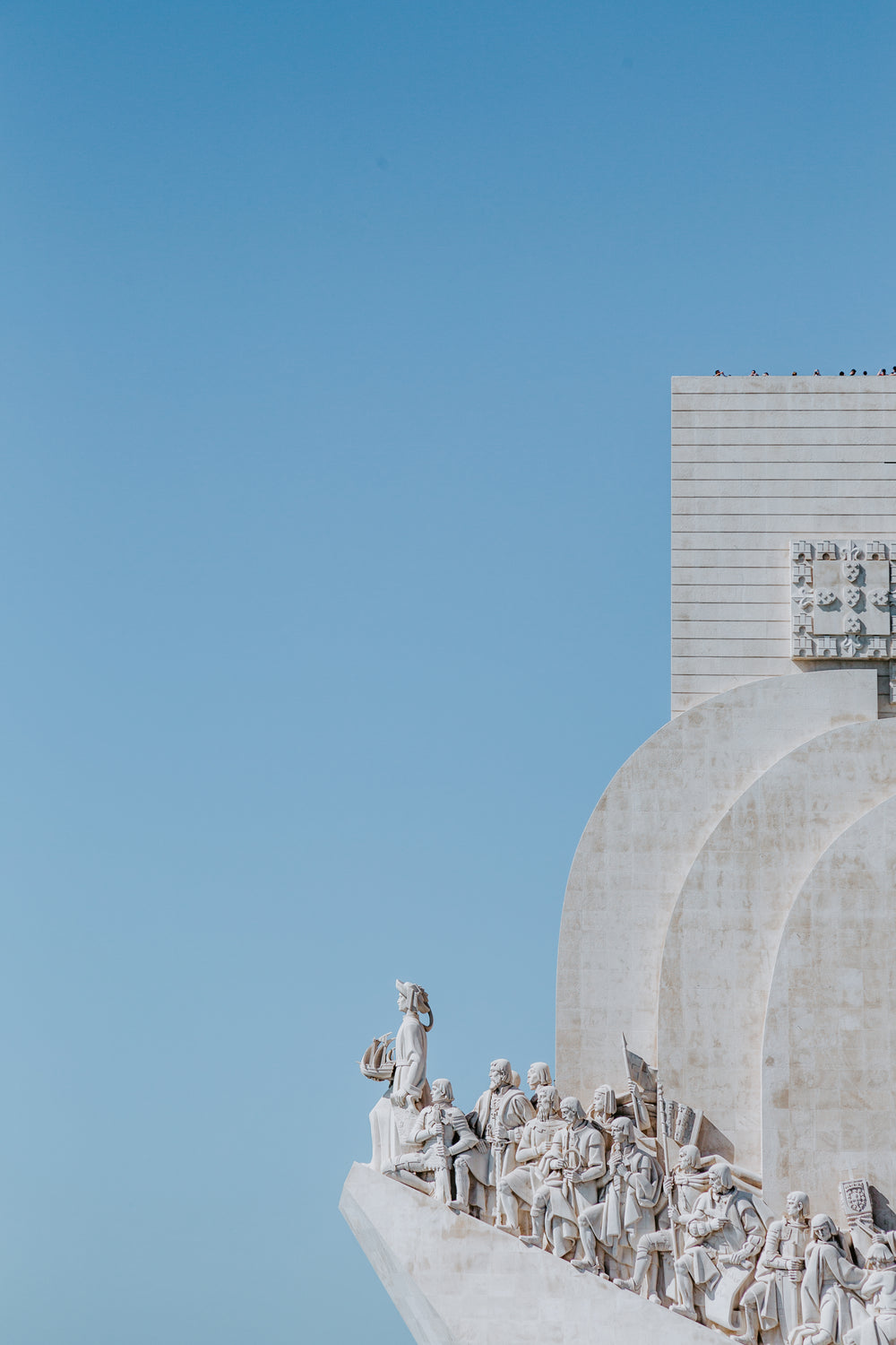 carved marble statues perched atop building