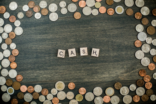 cash letters surrounded by coins