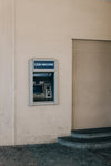cash machine on a beige wall