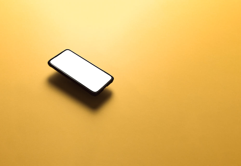 cellphone floats above a yellow background