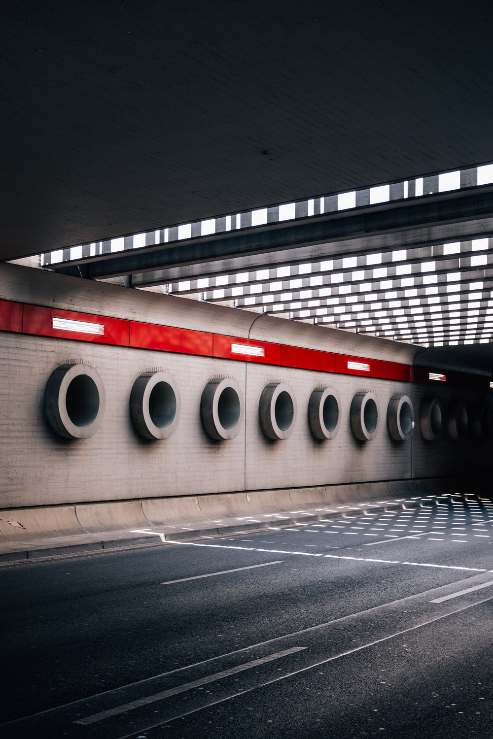 cement circles line the wall under an overpass