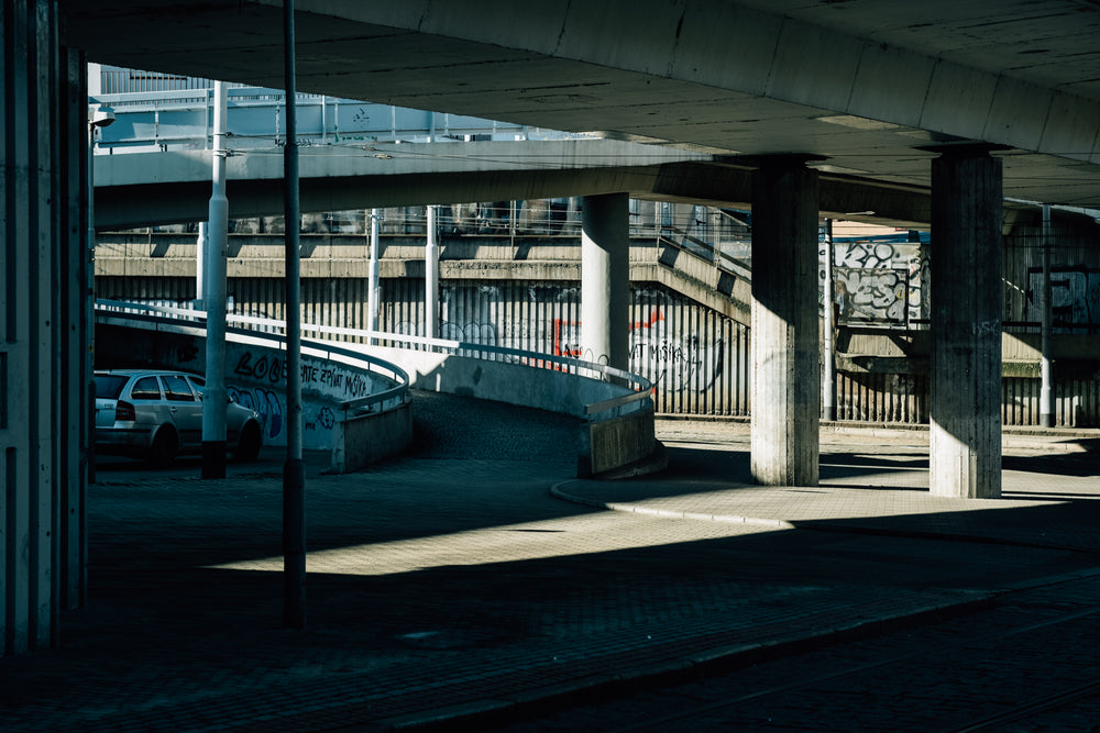 cement underpass of a city road with graffiti