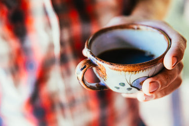 ceramic coffee cup in hand