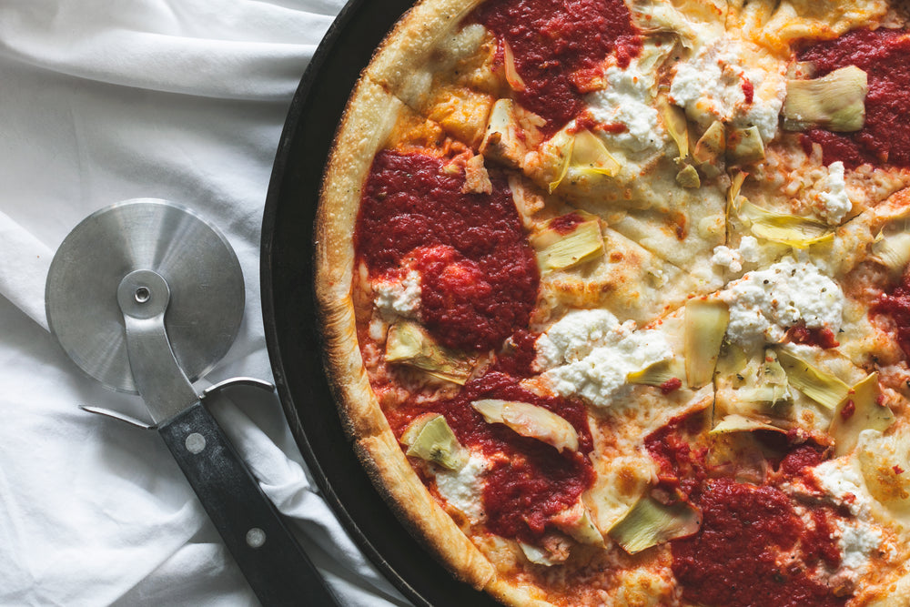 cheese and artichoke pizza with slicer