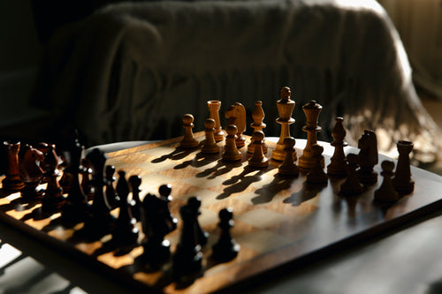 chess board bathed in light creating shadows