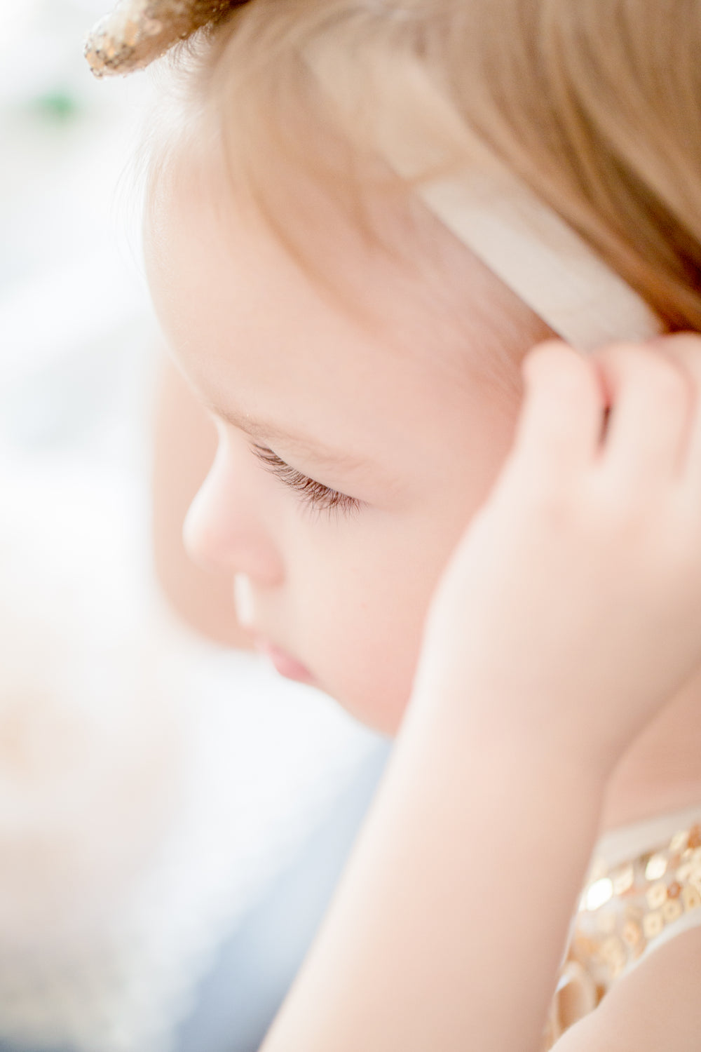 child adjusts their head band