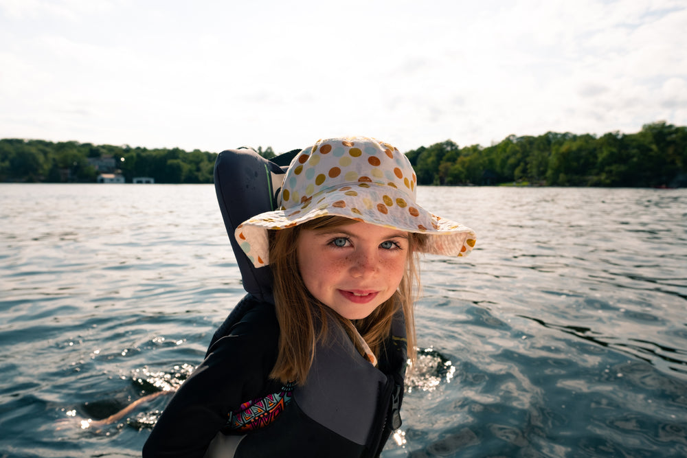 child in life jacket on boat