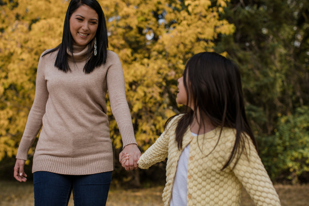 child leads a woman by the hand