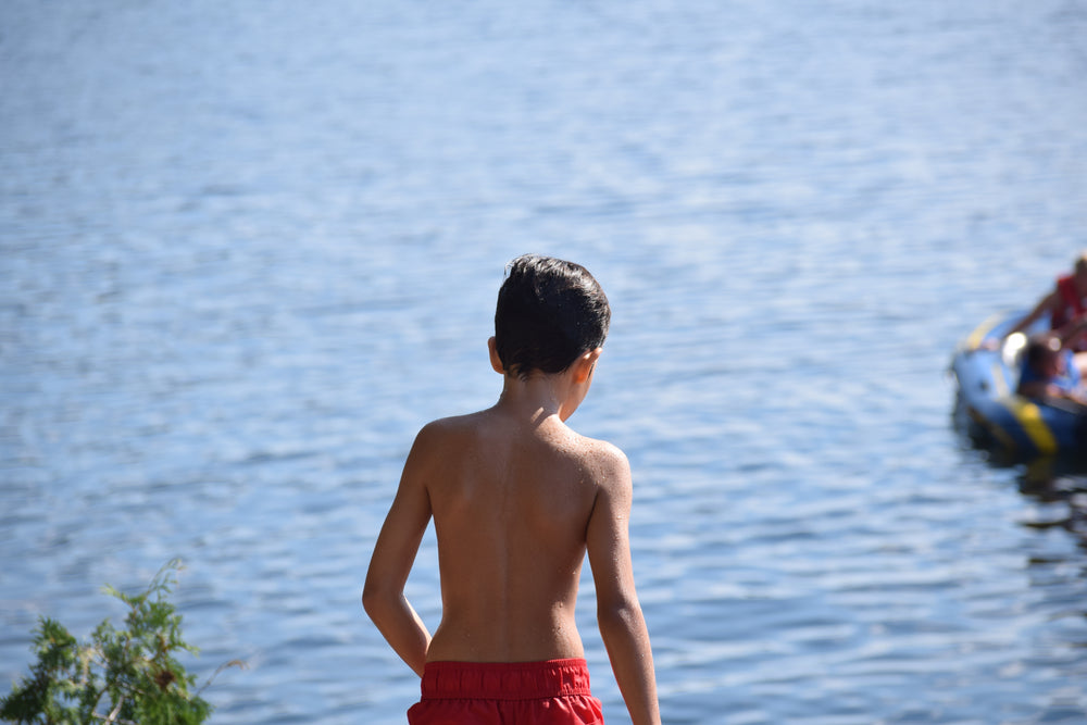child playing near lake