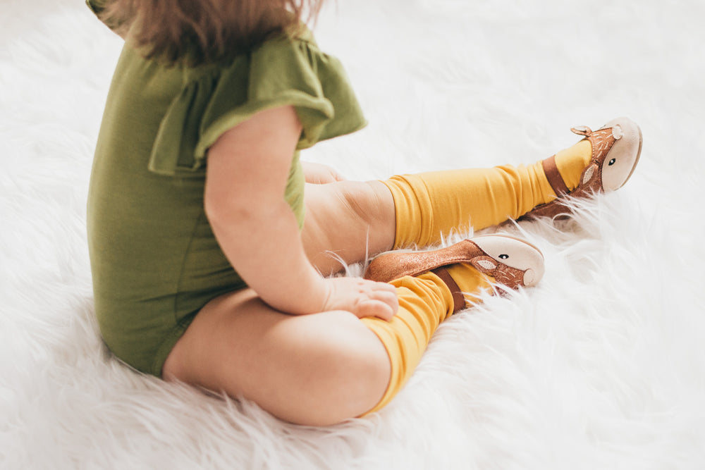 child sits on fluffy rug