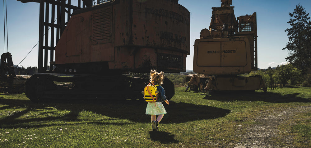 child walks surrounded by machinery