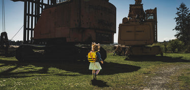 child walks surrounded by machinery