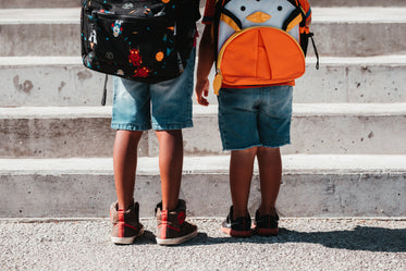 children wearing school bags