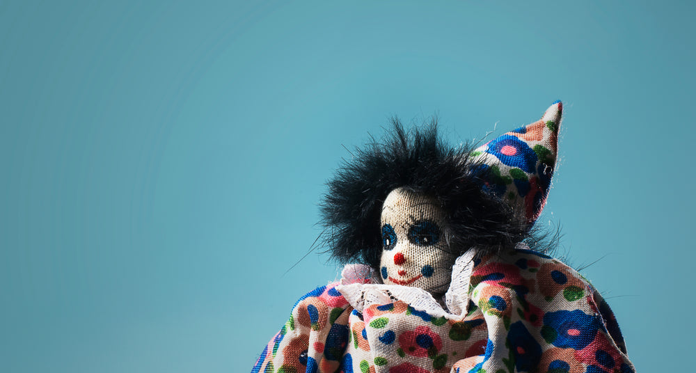 childs toy clown on blue