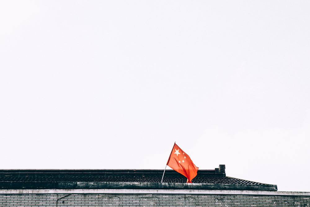 chinese flag on temple rooftop