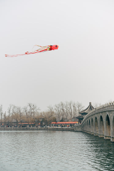 chinese flying kite over a river