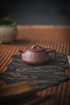 chinese teapot on a bamboo surface