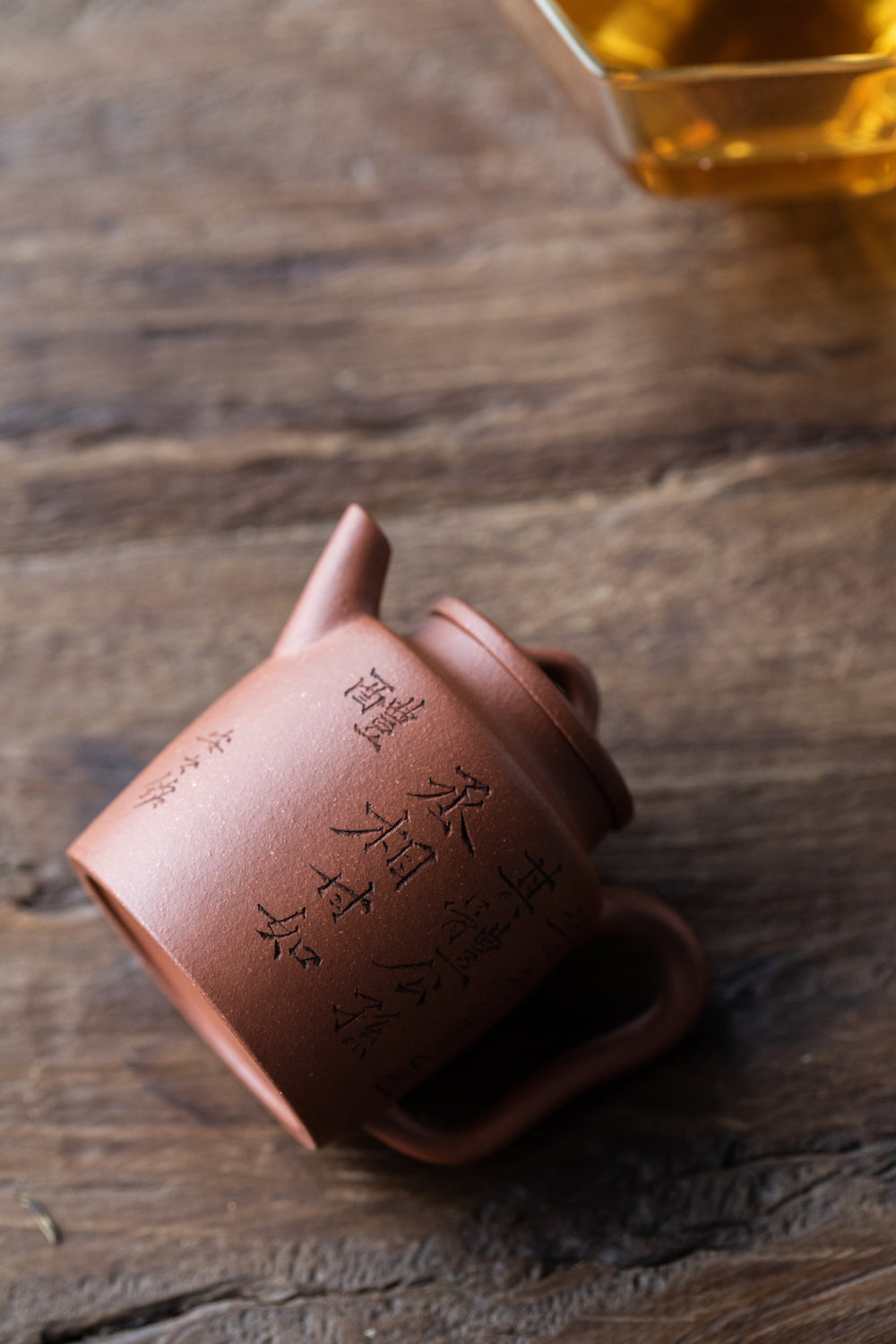 chinese teapot on it's side on wooden table