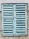 chipped blue paint on aging shutters