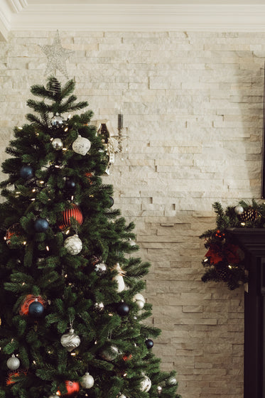 christmas tree in modern home by mantle