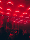 circular red lights above crowd