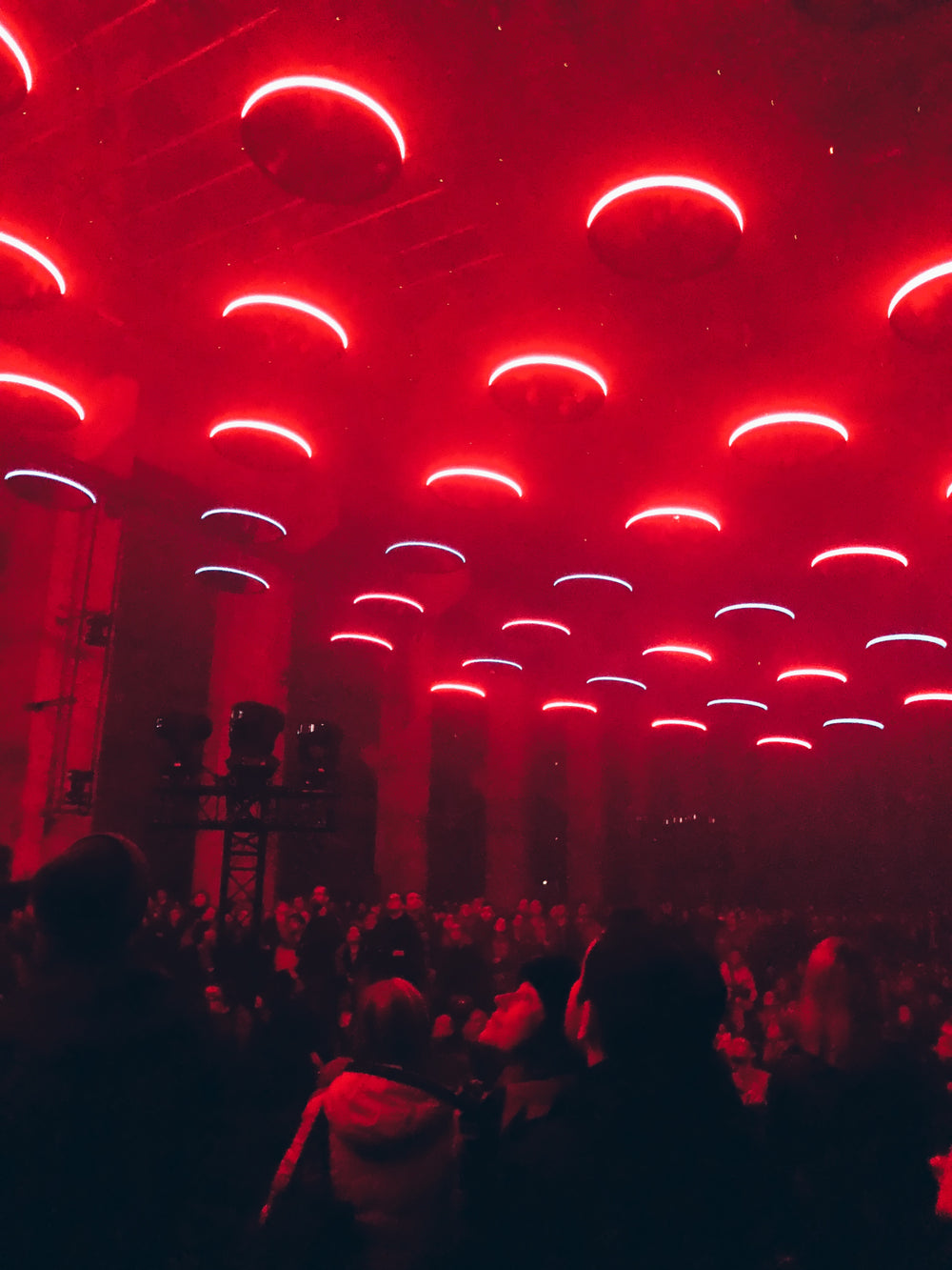 circular red lights above crowd