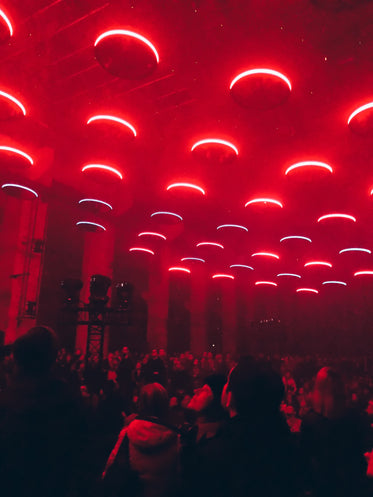 circular red lights above crowd