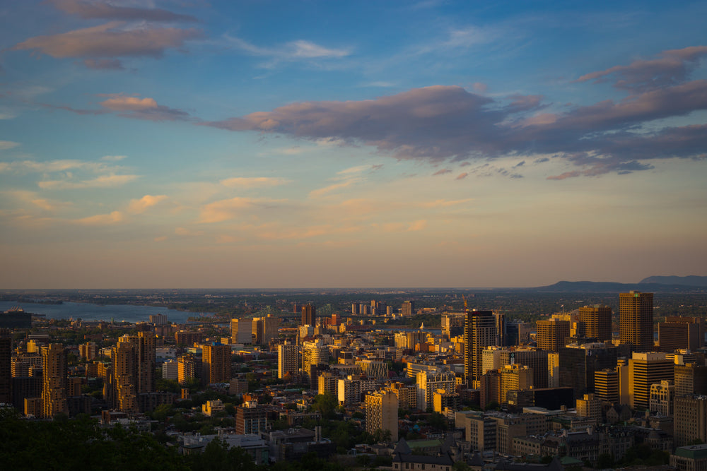 city at sunset with clouded sky