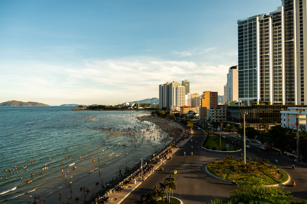 city buildings casts shadows next to a public beach