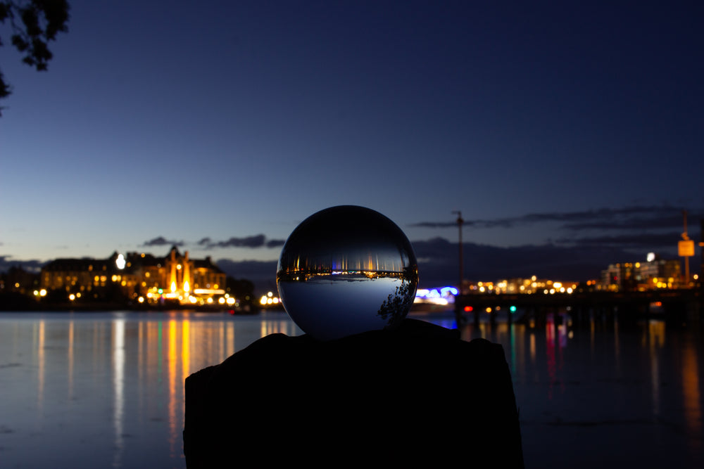 city lights at night reflected in a clear orb