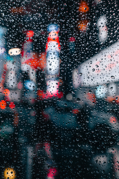 city lights through rain window