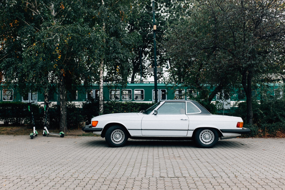 classic car parked under the trees