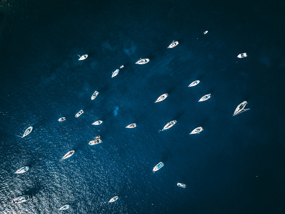 clear water with parked boats from above