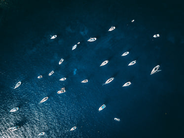 clear water with parked boats from above