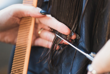 close up hands trimming hair