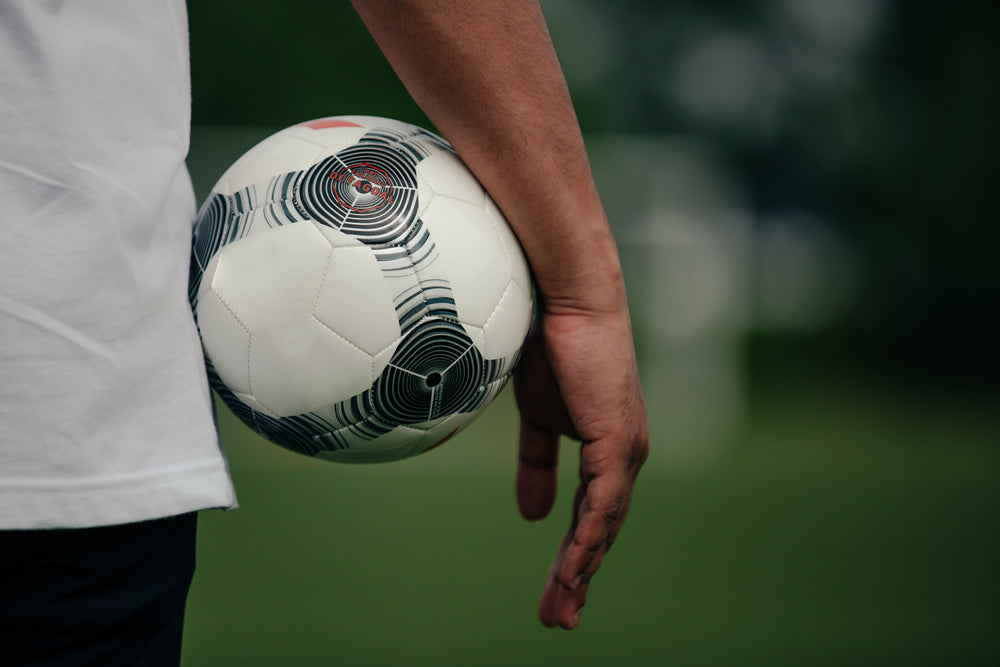 close up holding soccer ball